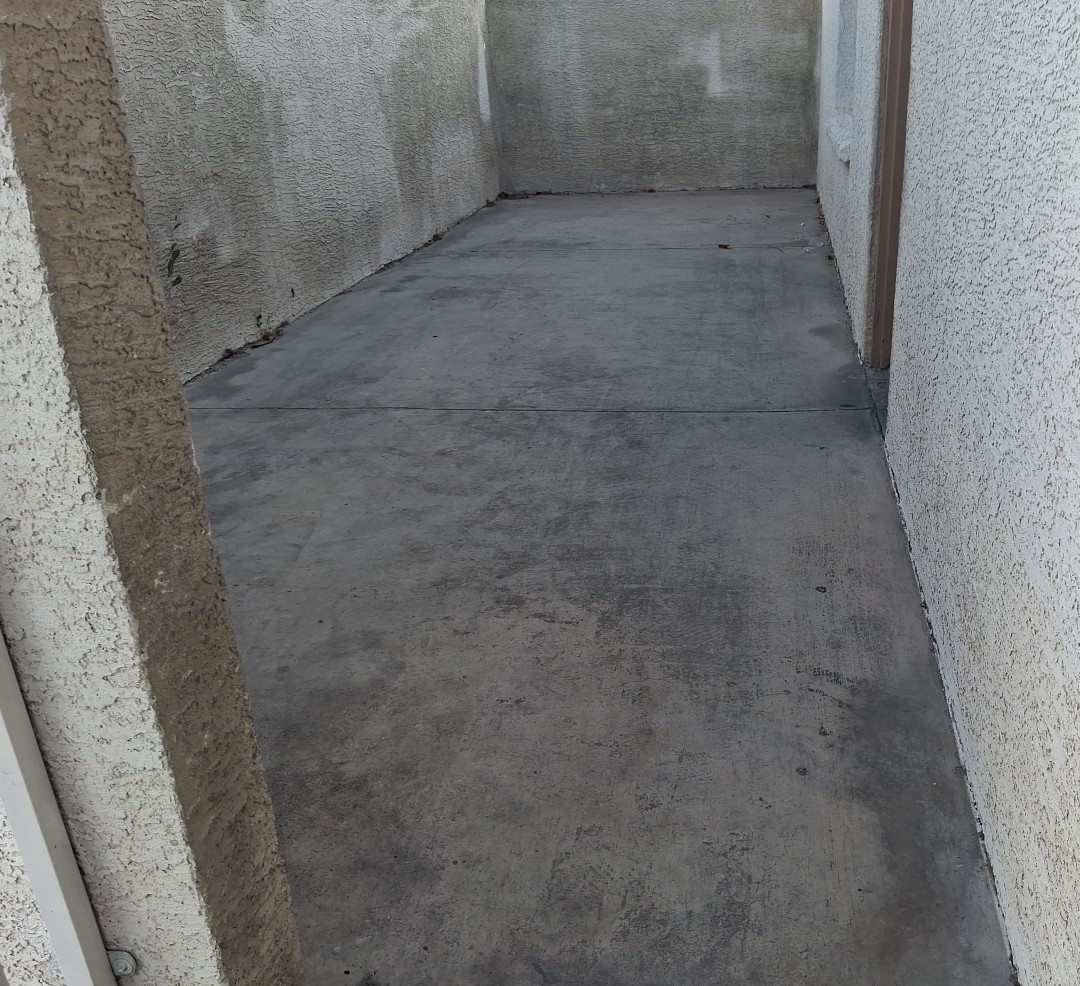 Greasy dumpster pad before cleaning